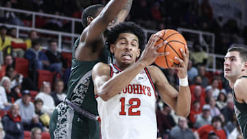 Nov 13, 2024; Queens, New York, USA;  St. John's basketball guard RJ Luis Jr. (12) drives past Wagner Seahawks forward Tyje Kelton (4) in the second half at Carnesecca Arena. Mandatory Credit: Wendell Cruz-Imagn Images
