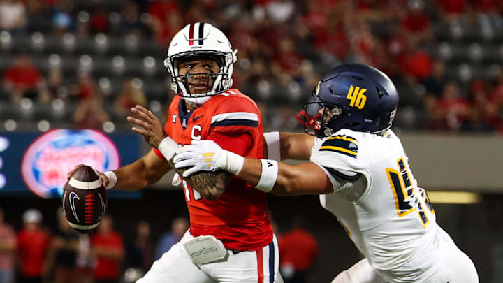 Sep 7, 2024; Tucson, Arizona, USA; Arizona Wildcats quarterback Noah Fifita (11) rolls out to pass against Northern Arizona Lumberjacks linebacker Tommy Ellis (46) during first quarter at Arizona Stadium. Mandatory Credit: Aryanna Frank-Imagn Images