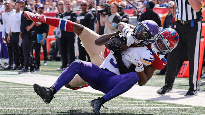 Sep 8, 2024; East Rutherford, New Jersey, USA; Minnesota Vikings wide receiver Jordan Addison (3) is tackled by New York Giants cornerback Dru Phillips (22) during the first half at MetLife Stadium.