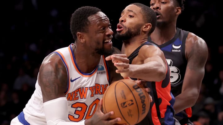 Dec 20, 2023; Brooklyn, New York, USA; New York Knicks forward Julius Randle (30) looks to shoot the ball against Brooklyn Nets forward Mikal Bridges (1) and forward Dorian Finney-Smith (28) during the first quarter at Barclays Center. Mandatory Credit: Brad Penner-USA TODAY Sports
