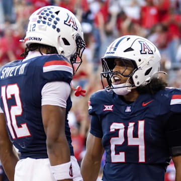 Nov 8, 2025; Tucson, Arizona, USA; Arizona Wildcats running back Quincy Craig (24) celebrates with wide receiver Tre Spivey (12) after rushing for a touchdown against the Kansas Jayhawks in the second half at Arizona Stadium. Mandatory Credit: Mark J. Rebilas-Imagn Images