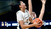 Vanderbilt forward Khamil Pierre (12) drives to the basket against Lipscomb forward Isabella Pitta, right, during an NCAA college basketball game Monday, Nov. 4, 2024, in Nashville, Tenn.