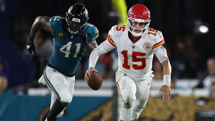 Oct 6, 2025; Jacksonville, Florida, USA; Kansas City Chiefs quarterback Patrick Mahomes (15) scrambles against Jacksonville Jaguars defensive end Josh Hines-Allen (41) during the second half at EverBank Stadium. Mandatory Credit: Nathan Ray Seebeck-Imagn Images