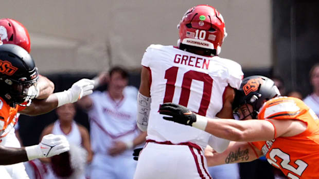 Oklahoma State's Jeff Roberson and Collin Oliver sack Arkansas' Taylen Green.