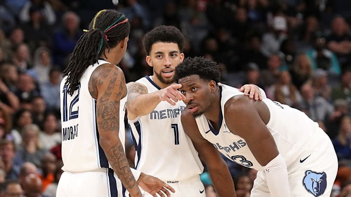 Ja Morant #12, Scotty Pippen Jr., and Jaren Jackson Jr. #13 of the Memphis Grizzlies talk during a break in action against the Portland Trail Blazers.