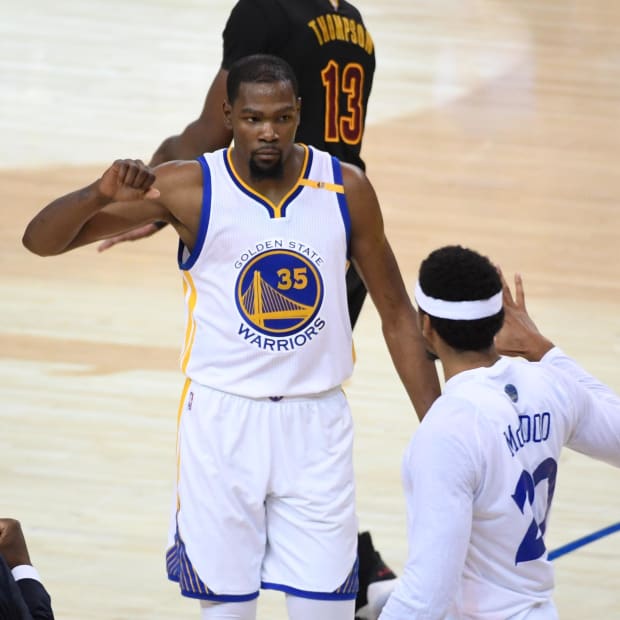 June 4, 2017; Oakland, CA, USA; Golden State Warriors forward Kevin Durant (35) celebrates with forward James Michael McAdoo (20) during the first quarter in game two of the 2017 NBA Finals against the Cleveland Cavaliers at Oracle Arena. The Warriors defeated the Cavaliers 132-113. Mandatory Credit: Kyle Terada-USA TODAY Sports