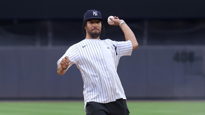 Jul 24, 2024; Bronx, New York, USA; New York Knicks guard Jalen Brunson throws out a ceremonial first pick before a game between the New York Yankees and New York Mets at Yankee Stadium. Mandatory Credit: Brad Penner-USA TODAY Sports