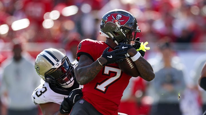 Jan 5, 2025; Tampa, Florida, USA; New Orleans Saints defensive tackle Nathan Shepherd (93) grabs the facemark of Tampa Bay Buccaneers running back Bucky Irving (7) in the third quarter at Raymond James Stadium. Mandatory Credit: Nathan Ray Seebeck-Imagn Images