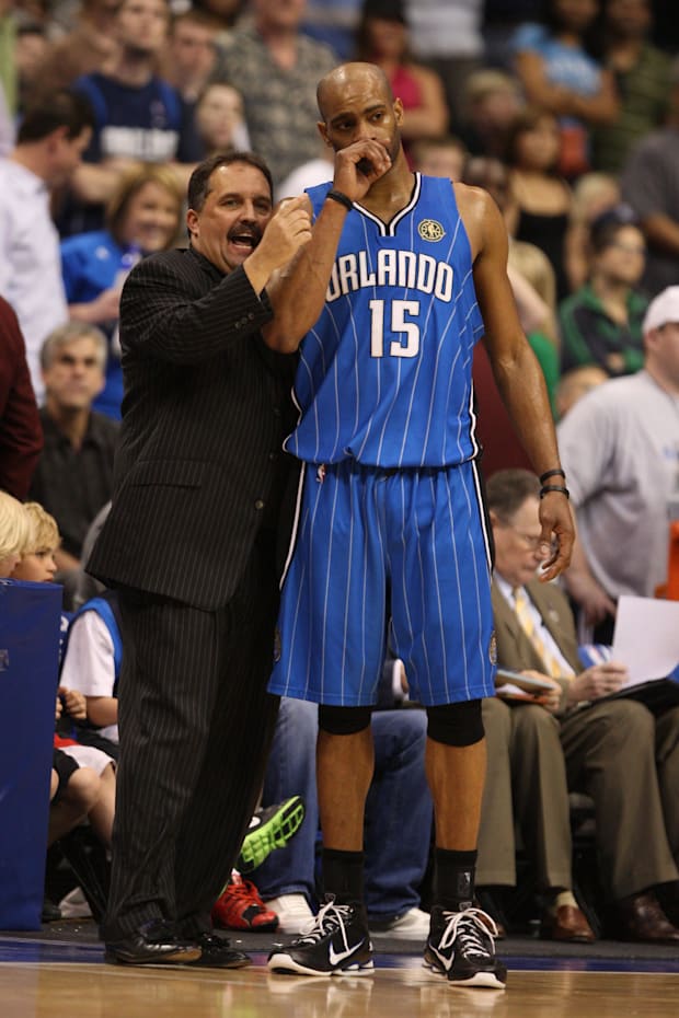 Orlando Magic guard Vince Carter (15) talks to head coach Stan Van Gundy during a timeout from the game against Dalla