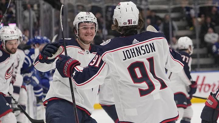 Dec 14, 2023; Toronto, Ontario, CAN; Columbus Blue Jackets forward Dmitri Voronkov (10) congratulates Columbus Blue Jackets forward Kent Johnson (91) after scoring the winning goal against the Toronto Maple Leafs during the overtime at Scotiabank Arena. Mandatory Credit: John E. Sokolowski-Imagn Images