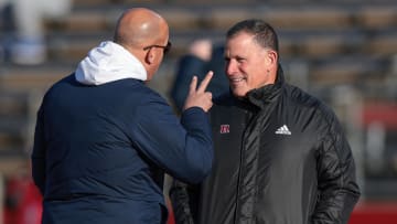 Penn State Nittany Lions head coach James Franklin (left) talks with Rutgers Scarlet Knights head coach Greg Schiano 