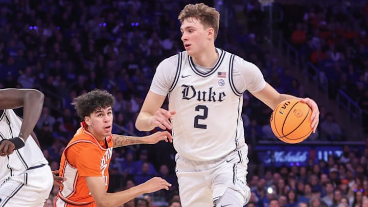 Feb 22, 2025; New York, NY, USA;  Duke basketball guard Cooper Flagg (2) drives past Illinois Fighting Illini forward Will Riley (7) in the first half at Madison Square Garden.