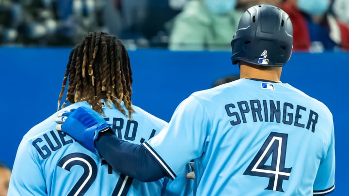 Toronto Blue Jays teammates George Springer and Vladimir Guerrero Jr. celebrate following a walk-off win earlier this year.