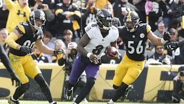 Oct 8, 2023; Pittsburgh, Pennsylvania, USA;  Baltimore Ravens quarterback Lamar Jackson (8) runs the ball as Pittsburgh Steelers linebackers T.J. Watt (90) and Alex Highsmith (56) chase during the fourth quarter at Acrisure Stadium. Mandatory Credit: Charles LeClaire-Imagn Images