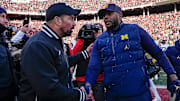 Ohio State Buckeyes head coach Ryan Day shakes hands with Michigan Wolverines head coach Sherrone Moore following Michigan's 13-10 victory.