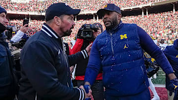 Ohio State Buckeyes head coach Ryan Day shakes hands with Michigan Wolverines head coach Sherrone Moore following Michigan's 13-10 victory.
