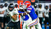 UCF Knights running back Isaiah Bowser (5) tries to educe Florida Gators safety Trey Dean III (0). The UCF Knights defeats the Florida Gators, 29-17 in the Gasparilla Bowl Thursday, December 23, 2021, at Raymond James Stadium in Tampa, FL. [Doug Engle/Ocala Star-Banner]2021

Oca 122324 Ufvsucfgasbowl