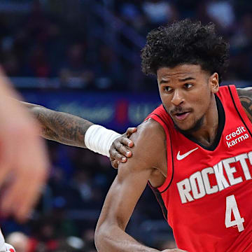 Apr 14, 2024; Los Angeles, California, USA; Houston Rockets guard Jalen Green (4) moves the ball against Los Angeles Clippers guard Terance Mann (14) during the first half at Crypto.com Arena. Mandatory Credit: Gary A. Vasquez-Imagn Images