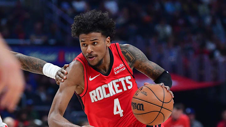 Apr 14, 2024; Los Angeles, California, USA; Houston Rockets guard Jalen Green (4) moves the ball against Los Angeles Clippers guard Terance Mann (14) during the first half at Crypto.com Arena. Mandatory Credit: Gary A. Vasquez-Imagn Images