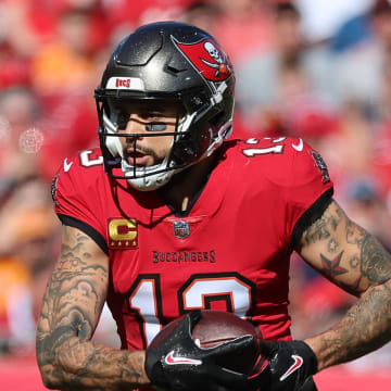 Dec 31, 2023; Tampa, Florida, USA; Tampa Bay Buccaneers wide receiver Mike Evans (13) runs with the ball against the New Orleans Saints during the first half at Raymond James Stadium. Mandatory Credit: Kim Klement Neitzel-USA TODAY Sports