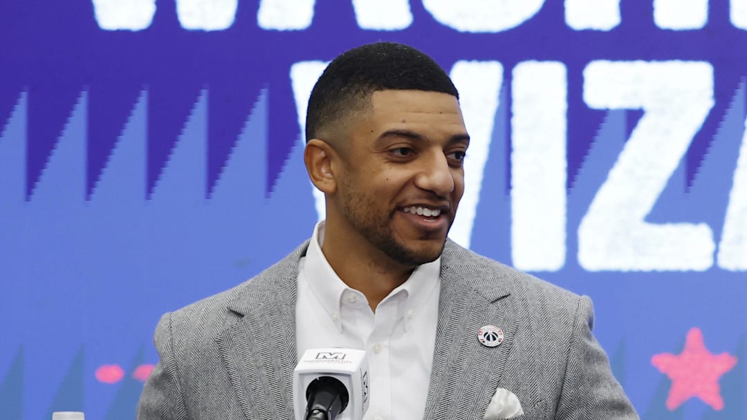 Jan 9, 2026; Washington, District of Columbia, USA; Washington Wizards general manager Will Dawkins (L) introduces newly acquired Wizards guard Trae Young (R) at a press conference prior to the Wizards' game against the New Orleans Pelicans at Capital One Arena. Mandatory Credit: Geoff Burke-Imagn Images