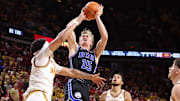 Mar 4, 2025; Ames, Iowa, USA; Brigham Young Cougars forward Richie Saunders (15) shoots over Iowa State Cyclones guard Tamin Lipsey (3) during the second half at James H. Hilton Coliseum. Mandatory Credit: Reese Strickland-Imagn Images