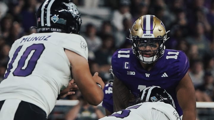 Alphonzo Tuputala stares across at Weber State QB Richie Munoz.