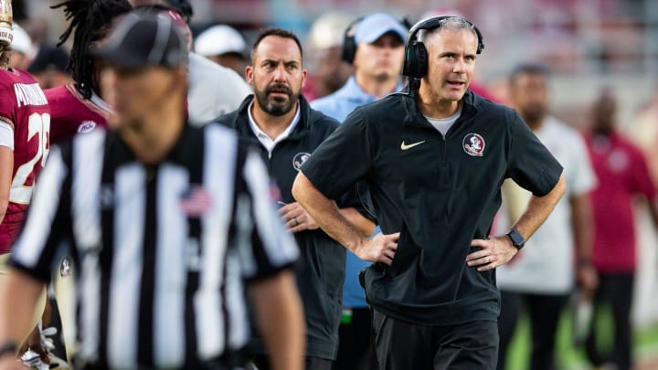 Florida State Seminoles head coach Mike Norvell talks on his headset as he coaches from the sideline. The Florida State Seminoles defeated the Virginia Tech Hokies 39-17 at Doak Campbell Stadium on Saturday, Oct. 7, 2023.