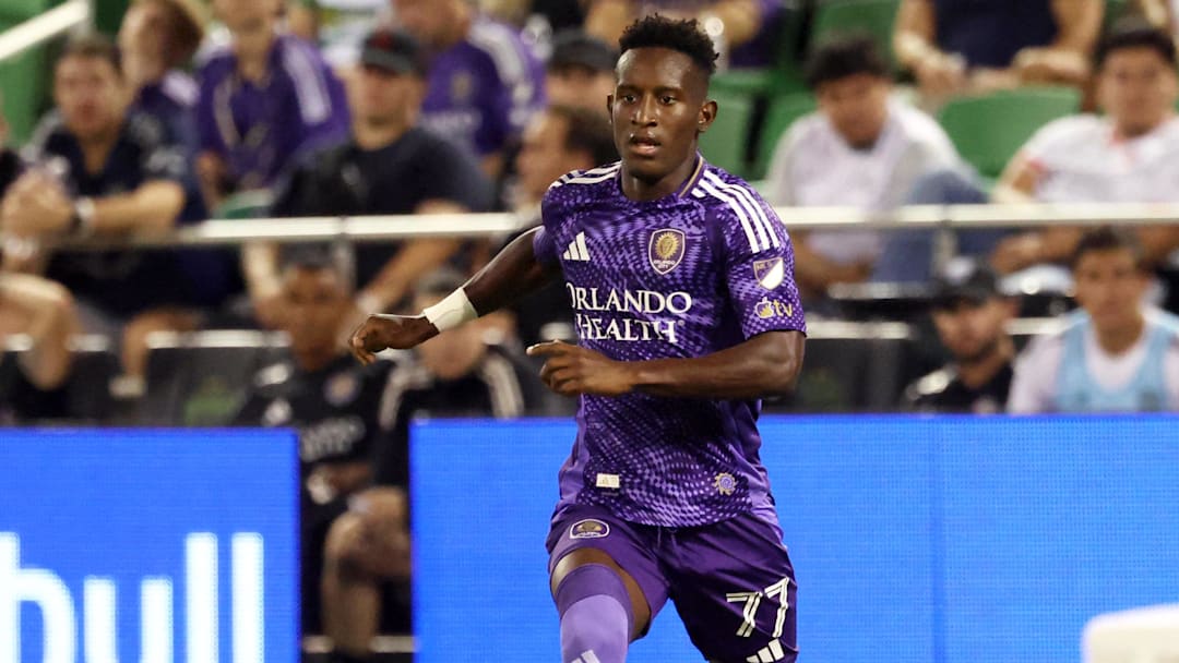 May 7, 2025; St. Petersburg, Florida, USA; Orlando City SC forward Iván Angulo (77) dribbles the ball against the Tampa Bay Rowdies defender Zakaria Taifi (96)  during the second half at Al Lang Stadium. Mandatory Credit: Kim Klement Neitzel-Imagn Images