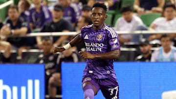 May 7, 2025; St. Petersburg, Florida, USA; Orlando City SC forward Iván Angulo (77) dribbles the ball against the Tampa Bay Rowdies defender Zakaria Taifi (96)  during the second half at Al Lang Stadium. Mandatory Credit: Kim Klement Neitzel-Imagn Images