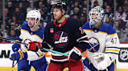 Mar 23, 2025; Winnipeg, Manitoba, CAN; Buffalo Sabres defenseman Mattias Samuelsson (23), Winnipeg Jets center Gabriel Vilardi (13) and Buffalo Sabres goaltender James Reimer (47) wait for an incoming shot in the second period at Canada Life Centre. Mandatory Credit: James Carey Lauder-Imagn Images
