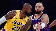 Dec 1, 2025; Los Angeles, California, USA; Los Angeles Lakers forward LeBron James (23) moves the ball against Phoenix Suns forward Dillon Brooks (3) during the first half at Crypto.com Arena. Mandatory Credit: Gary A. Vasquez-Imagn Images
