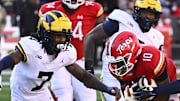 Nov 18, 2023; College Park, Maryland, USA; Maryland Terrapins wide receiver Tai Felton (10) runs after a catch between Michigan Wolverines defensive back Makari Paige (7) and defensive back Will Johnson (2) during the second half at SECU Stadium. Mandatory Credit: Brad Mills-Imagn Images