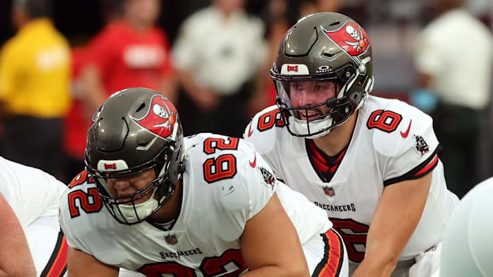 Aug 23, 2024; Tampa, Florida, USA; Tampa Bay Buccaneers center Graham Barton (62) hikes the ball to Tampa Bay Buccaneer quarterback Baker Mayfield (6) against the Miami Dolphins  during the first quarter at Raymond James Stadium. Mandatory Credit: Kim Klement Neitzel-Imagn Images