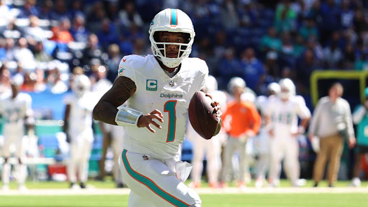 Sep 7, 2025; Indianapolis, Indiana, USA; Miami Dolphins quarterback Tua Tagovailoa (1) rolls out during the second half against the Indianapolis Colts at Lucas Oil Stadium. Mandatory Credit: Trevor Ruszkowski-Imagn Images
