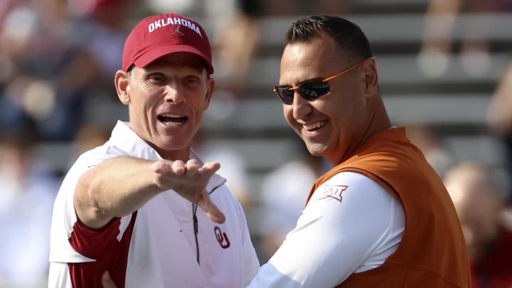 Oklahoma Sooners coach Brent Venables (left) speaks with Texas Longhorns coach Steve Sarkisian (right) before the game at the Cotton Bowl.