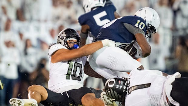 Oregon linebacker Matayo Uiagalelei tackles Penn State running back Nicholas Singleton in the Ducks' win.