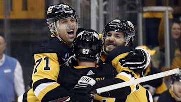 Mar 12, 2023; Pittsburgh, Pennsylvania, USA; Pittsburgh Penguins center Sidney Crosby (87) and center Evgeni Malkin (71) and defenseman Kris Letang (right) celebrate a game winning goal in overtime by Letang to defeat the New York Rangers at PPG Paints Arena. The Penguins won 3-2 in overtime. Mandatory Credit: Charles LeClaire-Imagn Images