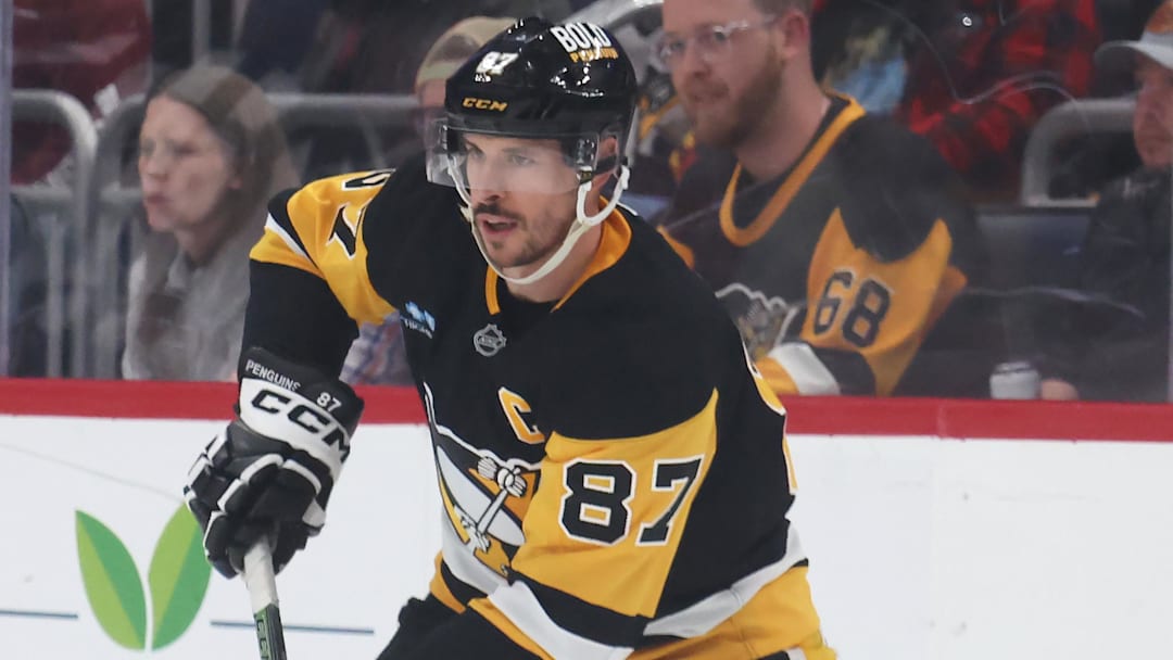 Apr 17, 2025; Pittsburgh, Pennsylvania, USA;  Pittsburgh Penguins center Sidney Crosby (87) moves the puck against the Washington Capitals during the second period at PPG Paints Arena. Mandatory Credit: Charles LeClaire-Imagn Images