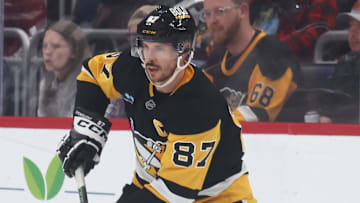 Apr 17, 2025; Pittsburgh, Pennsylvania, USA;  Pittsburgh Penguins center Sidney Crosby (87) moves the puck against the Washington Capitals during the second period at PPG Paints Arena. Mandatory Credit: Charles LeClaire-Imagn Images