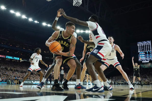 Purdue Boilermakers forward Mason Gillis (0) is trapped by Connecticut Huskies defenders in the national championship game of the Final Four of the 2024 NCAA Tournament at State Farm Stadium. 