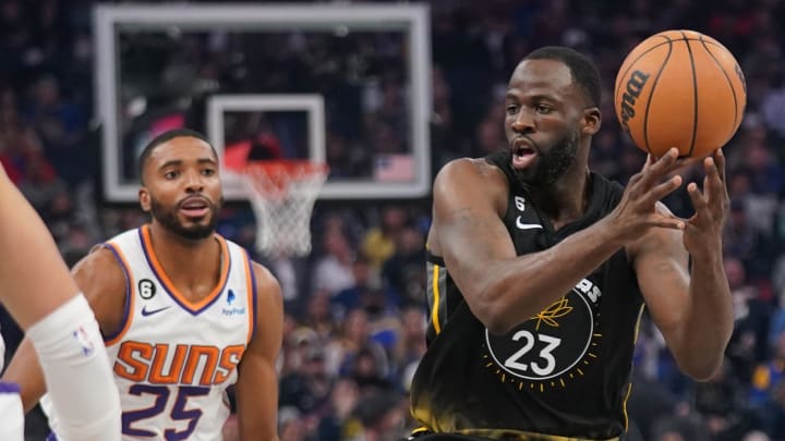 Jan 10, 2023; San Francisco, California, USA; Golden State Warriors forward Draymond Green (23) loses control of the ball in front of Phoenix Suns forward Mikal Bridges (25) in the second quarter at the Chase Center. Mandatory Credit: Cary Edmondson-USA TODAY Sports