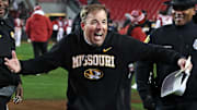 Nov 29, 2025; Fayetteville, Arkansas, USA; Missouri Tigers head coach Eli Drinkwitz celebrates after a game against the Arkansas Razorbacks at Donald W. Reynolds Razorback Stadium. Missouri won 31-17. Mandatory Credit: Nelson Chenault-Imagn Images