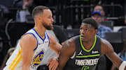 Mar 24, 2024; Minneapolis, Minnesota, USA; Golden State Warriors guard Stephen Curry (30) defends Minnesota Timberwolves guard Anthony Edwards (5) in the third quarter at Target Center. Mandatory Credit: Brad Rempel-Imagn Images