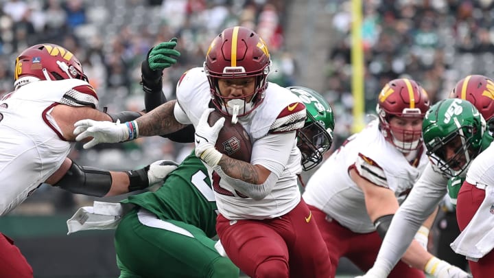 Dec 24, 2023; East Rutherford, New Jersey, USA; Washington Commanders running back Chris Rodriguez Jr. (23) scores a rushing touchdown during the first half against the New York Jets at MetLife Stadium. Mandatory Credit: Vincent Carchietta-USA TODAY Sports 