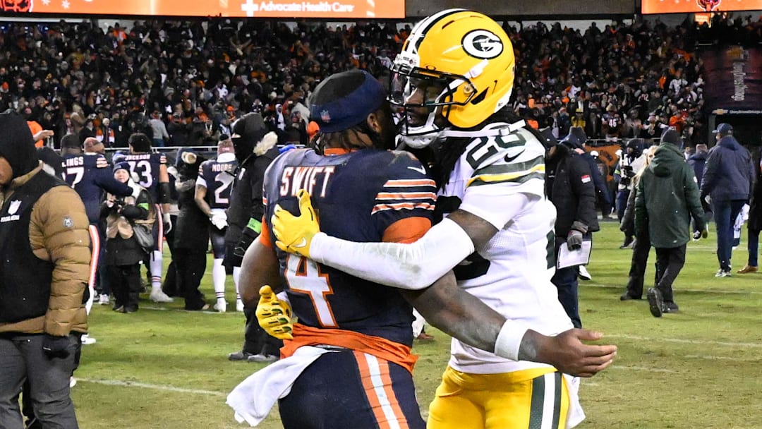 Jan 10, 2026; Chicago, IL, USA; in Chicago Bears running back D'Andre Swift (4) and Green Bay Packers cornerback Trevon Diggs (28) hug after an NFC Wild Card Round game at Soldier Field.