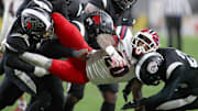 McKeesport's Kemon Spell (20) gets taken to the ground by multiple Aliquippa defenders during the second half of the WPIAL 4A Championship game Friday evening at Acrisure Stadium in Pittsburgh, PA.