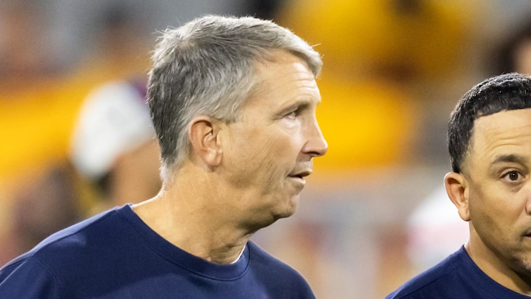 Nov 28, 2025; Tempe, Arizona, USA; Arizona Wildcats head coach Brent Brennan (left) with wide receivers coach Bobby Wade against the Arizona State Sun Devils during the 99th Territorial Cup at Mountain America Stadium. Mandatory Credit: Mark J. Rebilas-Imagn Images