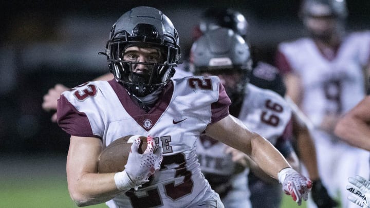 Carson Secchiari (23) carries the ball during the Tate vs Navarre football game at Navarre High School on Friday, Sept. 15, 2023.