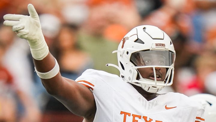 Texas White team offensive lineman Malik Agbo (67) signals for a call in the third quarter of the Longhorns' spring game.